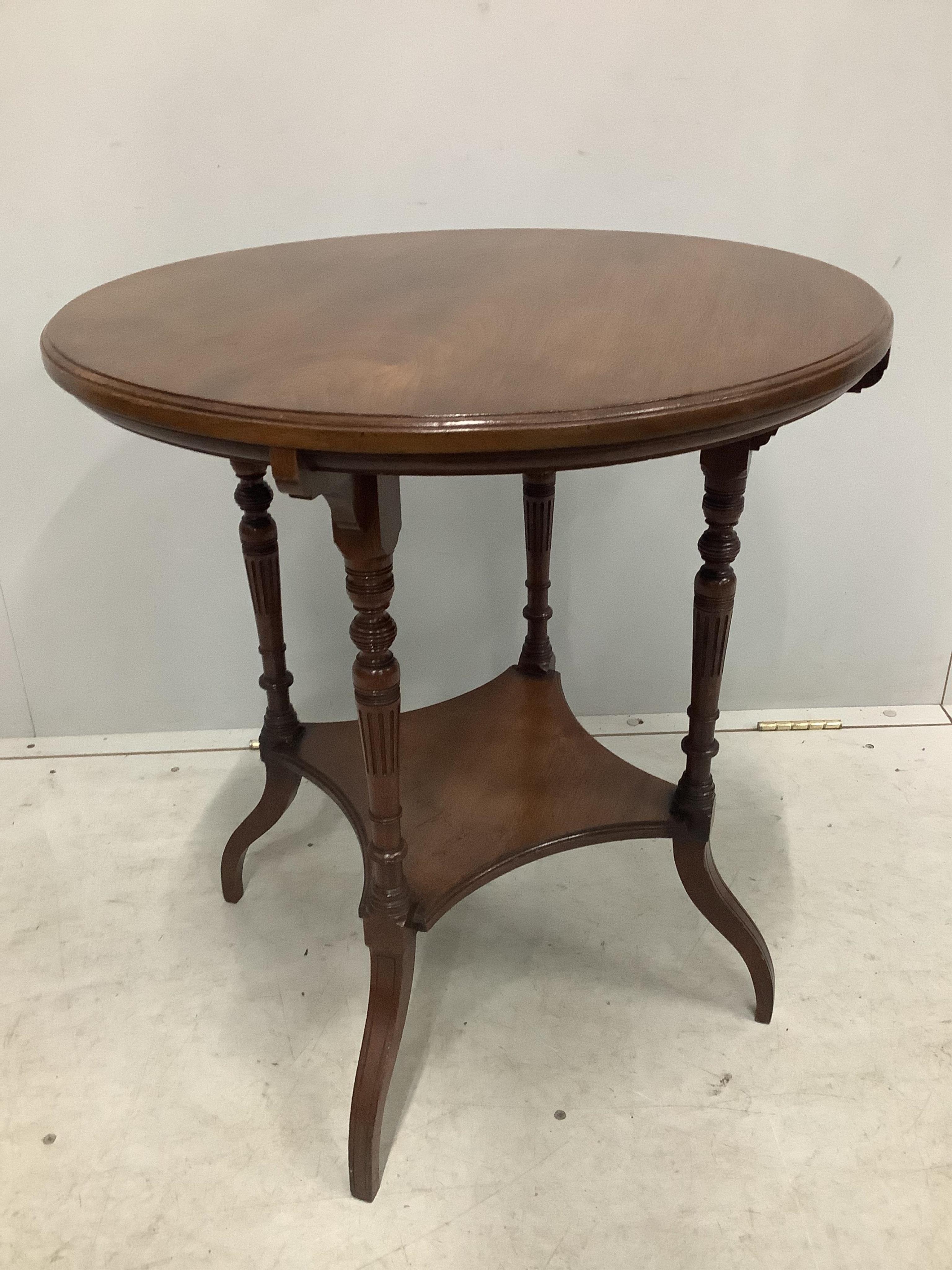 A late Victorian circular walnut two tier occasional table, stamped Gillow &Co ,1555, diameter 60cm, height 65cm. Condition - fair to good